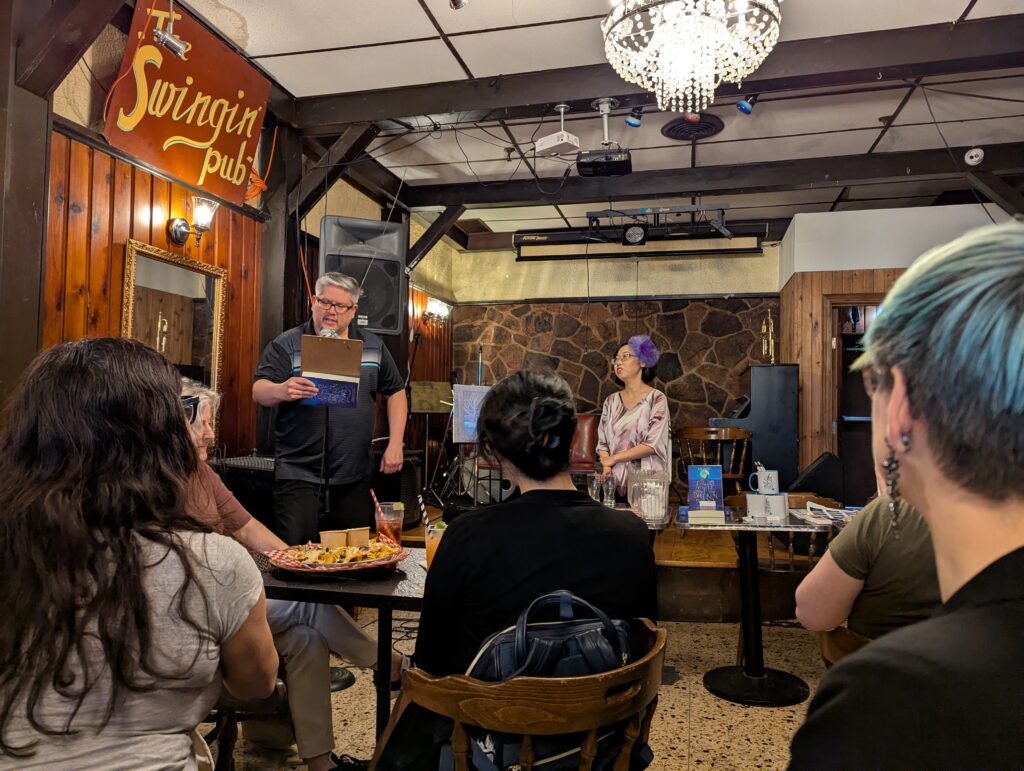 A crowd of folks at the book launch, including P.G. Reynolds, author of the Flick Gibson series.