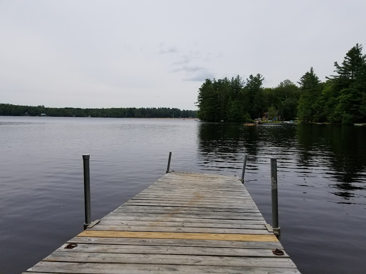 An image of a lonely dock jutting out into the lake.